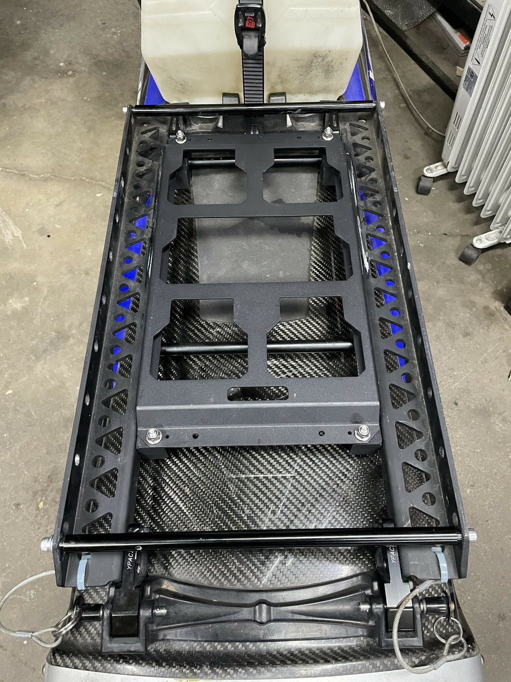 Black metal frame with carbon fiber texture on a concrete floor