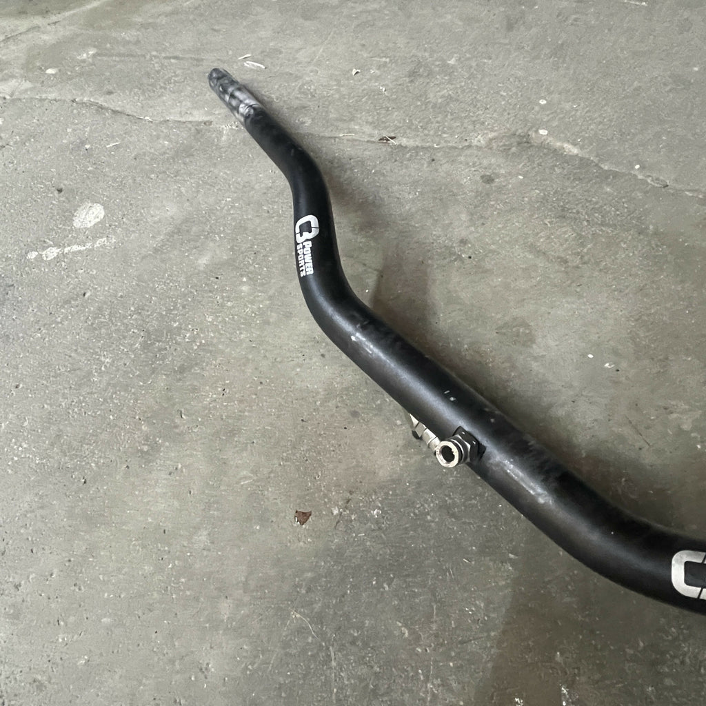 Black motorcycle handlebar on a concrete floor